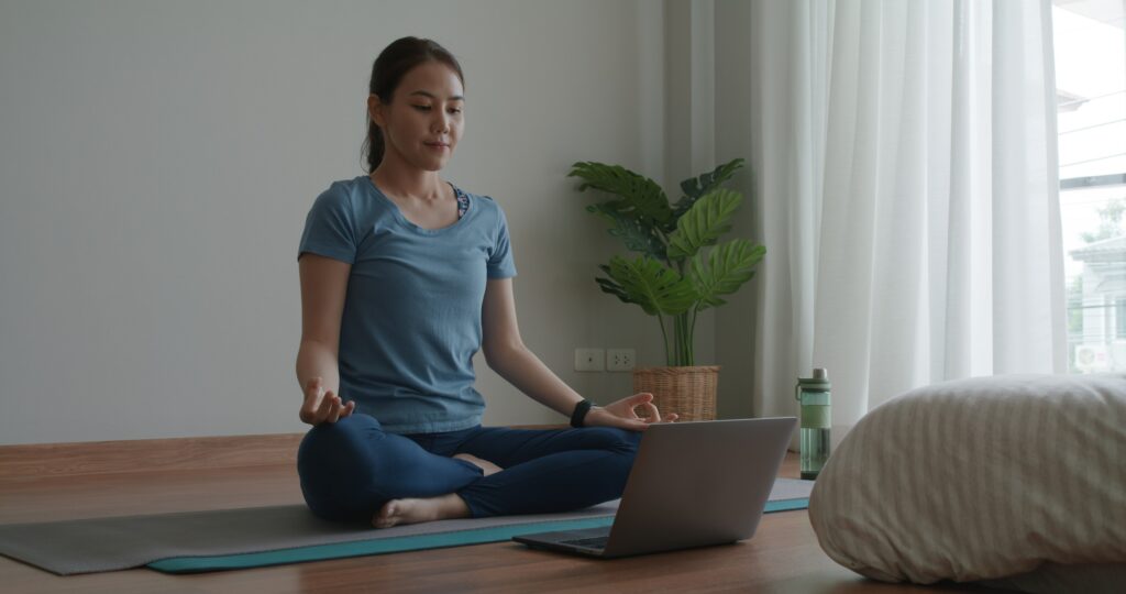 Asia people sport woman enjoy study happy watch live video sit on yoga mat