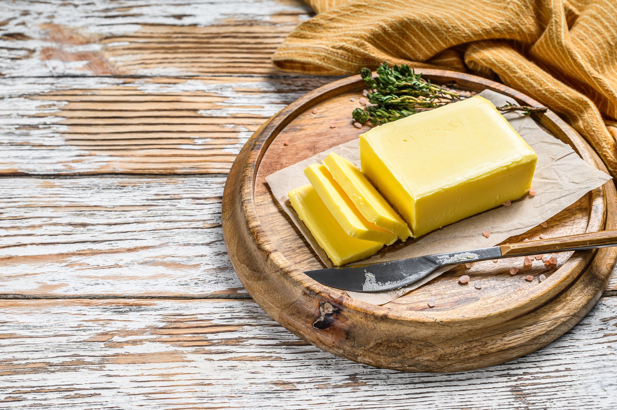Farm Butter, organic dairy products. White wooden background.Top view. Copy space