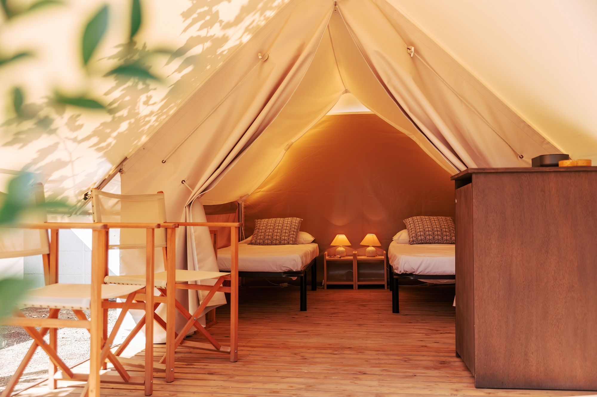Glamping tent with cozy interior on a sunny day. Luxury camping tent