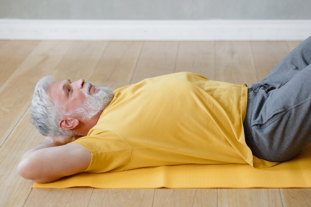 senior yoga shavasana or meditation for health promotion. do sports fitness or yoga at home